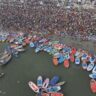 Aerial shot showcasing the bustling crowd and colorful boats at Kumbh Mela in Prayagraj.