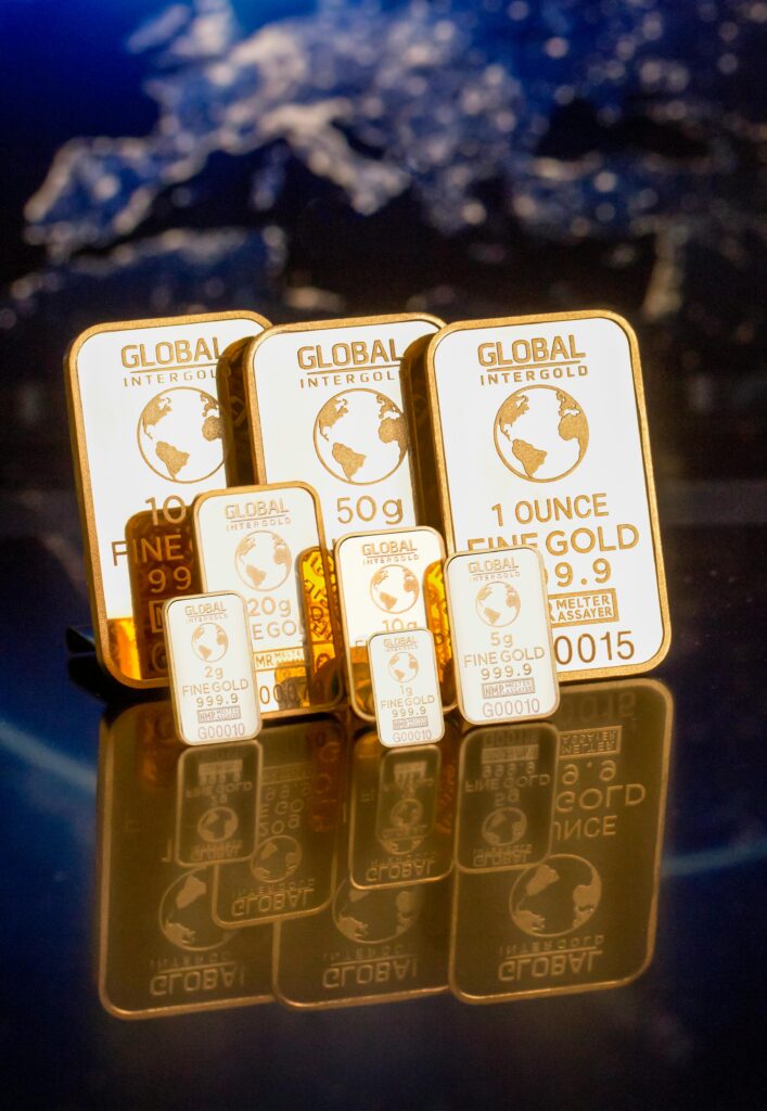 Collection of gold bars featuring a global map and weight inscriptions.